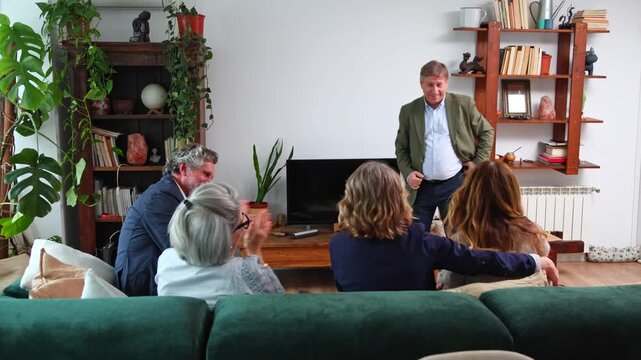 Family and friends playing charades at home