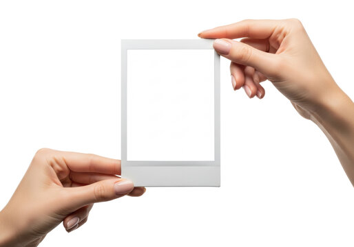 young caucasian woman's hands elegantly presenting a blank white instant photo frame mockup in a high-key studio with deep focus and zero shadows. concept for commercial advertising mockup