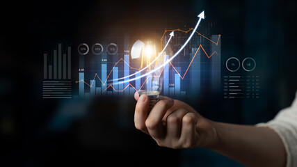 A hand holds a light bulb symbolizing innovative ideas amidst colorful charts and graphs, representing business growth in a digital landscape of data analysis. Scalp