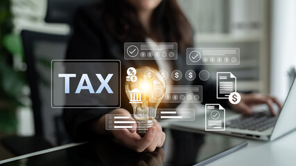 A woman holds a light bulb symbolizing innovation in tax planning, surrounded by financial concepts and documents, showcasing modern business solutions in an office environment. Gantry