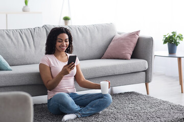 Video call conference, social distancing. Happy young black lady have chat on mobile phone at home,...