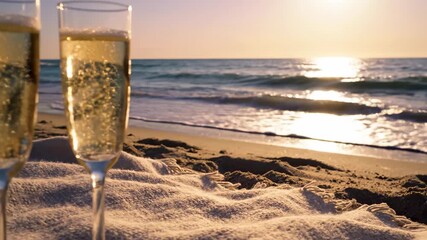 Champagne Toast at Sunset: Two champagne flutes, filled with effervescent champagne, stand on a sandy beach, framing a breathtaking sunset over the ocean, inviting viewers to indulge in the moment.