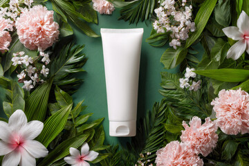 Blank white cosmetic tube mockup flowers, leaves background, ai generated