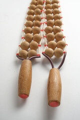 Wooden massage roller on a white background. Spa and wellness.