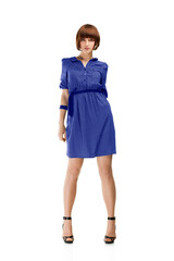 Woman in blue dress posing in studio, isolated on white background