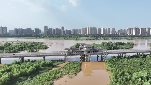 River Bridge Cityscape with Vegetation on Both Sides