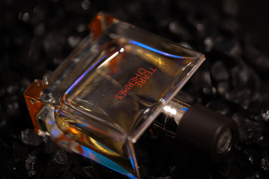 Bucharest Romania 19 January 2026. Moody still life of a men&rsquo;s perfume bottle set between black stones. Dark tones and minimal composition symbolizing mystery, power, and refinement.