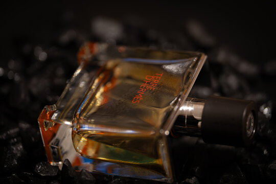 Bucharest Romania 19 January 2026. Moody still life of a men&rsquo;s perfume bottle set between black stones. Dark tones and minimal composition symbolizing mystery, power, and refinement.