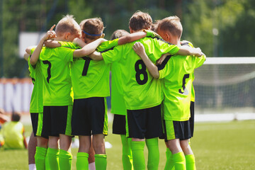 Young football soccer players in sportswear. Young sports team united. Team tactic talk before the...