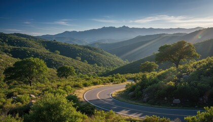 Scenic Winding Road Through Lush Green Hills and Distant Mountains Bathed in Sunlight