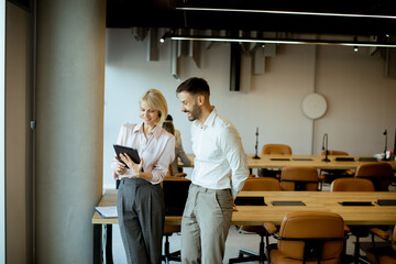Meeting between coworkers in a modern office discussing ideas and sharing information