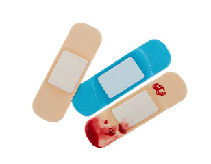 three adhesive bandages in various colors on transparent background