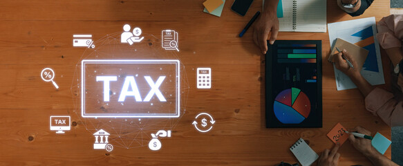 A well-organized workspace featuring financial tools, charts, and digital signage elements emphasizes collaboration for effective tax planning and financial analysis. Trope