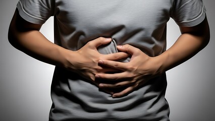 Obraz premium Person holding abdomen, experiencing pain, highlighting discomfort, suffering, health issue, disease