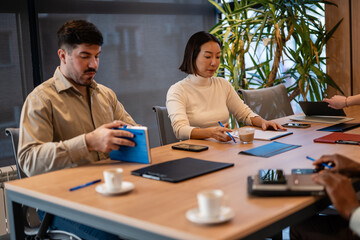Diverse business team collaborating during meeting in modern office