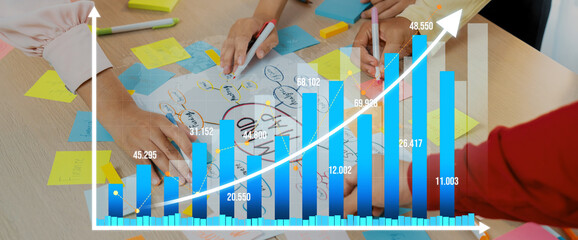 Creative business team brainstorming about marketing strategy and business plan by using mind mapping. Startup team work together to write down on paper. Focus on hand. Closeup. Variegated. Amity