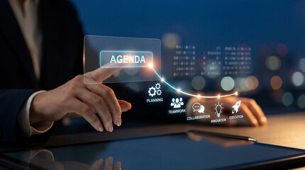 A person interacting with a futuristic transparent tablet displaying data and graphs in a dark office setting with city lights