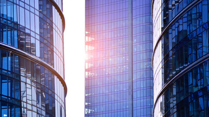 Fototapeta premium Modern office building exterior made from glass and steel. Windows of office building. Abstract architectural concept with sunlight. 