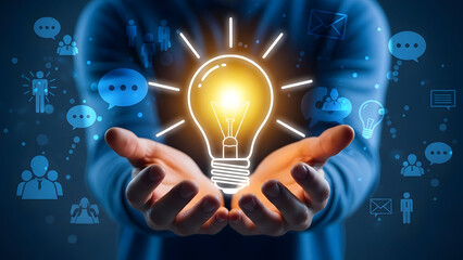 Hands holding a glowing light bulb icon surrounded by communication and business icons hands, holding
