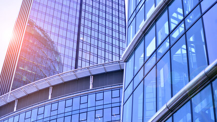 Obraz premium Modern office building exterior made from glass and steel. Windows of office building. Abstract architectural concept with sunlight. 