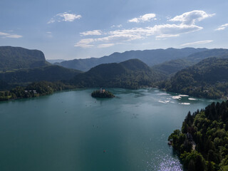 Aerial view of Bled Castle overlooking Lake Bled, Slovenia. Medieval fortress on a cliff captured by drone, surrounded by alpine landscape and clear blue water. Famous European travel destination and 