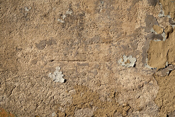 An old painted wall with peeling paint as a background.