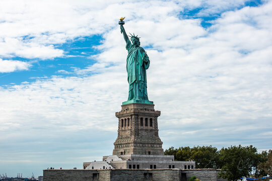 New York, USA - September 31, 2018: Statue of Liberty National Monument with blue sky background. Tourists visiting Liberty National Monument and Liberty Island. New York, USA.
