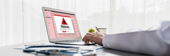 Cyber attacking concept. Malware alert showing on computer screen display scam and threat detection on computer system or online server to be removed brisk.