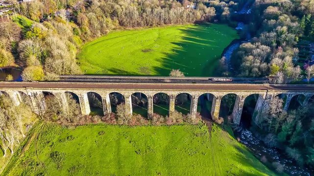 A rising aerial view flying above the Chirk viaduct in Wrexham, Wales