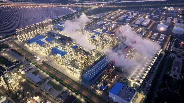 Illuminated oil refinery at twilight