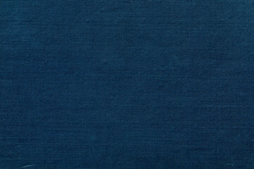 Dark blue cover of an antique book displaying a visible linen fiber texture.