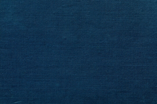 Dark blue cover of an antique book displaying a visible linen fiber texture.