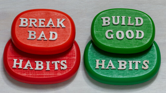 Break bad habits words on red wooden blocks and build good habits words on green blocks. Motivation and self-development concept.