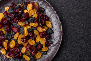 Dried cranberries, yellow and black sweet raisins as ingredients for a breakfast. Raisins and...