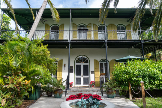 Key West, Florida: Ernest Hemingway House, residence of American writer Ernest Hemingway in the 1930s. Exterior of French Colonial style home with porch, balcony, and shutters. 