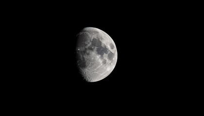 The Moon Partially Illuminated Against The Dark Night Sky