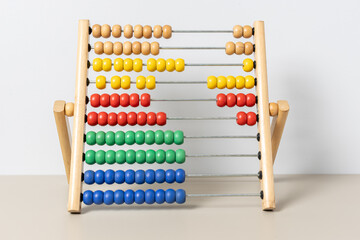 Colorful wooden abacus on table developing childhood math skills and learning