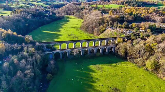 A distant rotating aerial view on the south side of the viaduct and aqueduct at Chirk, Wrexham, Wales