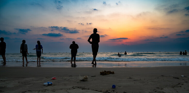 Sunset at Colva Goa beach in South India, silhouette of people, tropical west coast, Arabian Sea in Asia, vacation destination