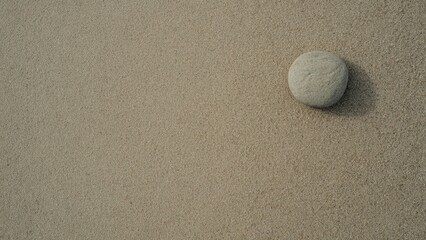 Smooth Round Stone on Beige Sand