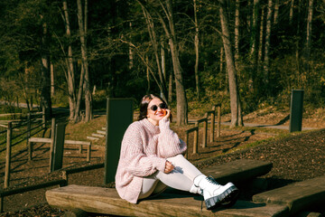 Fototapeta premium Young caucasian woman relaxing in park on sunny day