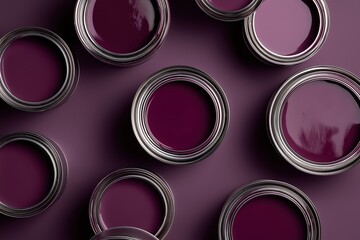 Flat lay of open paint cans filled with various shades of deep purple paint
