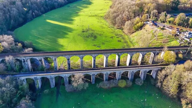 A rising aerial view flying above the south side of the viaduct and aqueduct at Chirk, Wrexham, Wales