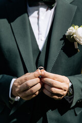Close-up photo of a gold wedding ring in a man's hands