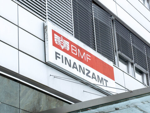 Villach, Austria - January 19, 2026: BMF Finanzamt sign displayed on a modern building exterior with large windows and a sleek architectural design in an urban setting
