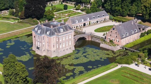 central castle connected outbuildings via prominent stone bridge high lily covered moat middachten netherlands to angle aerial shot estate lily-covered gelderland 