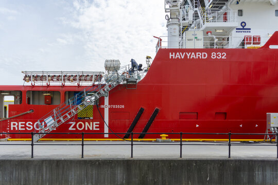KRISTIANSUND, NORWAY - AUGUST 08, 2021: Red Havyard 832 Platform Supply Vessel Docked at Port featuring Rescue Zone and Gangway