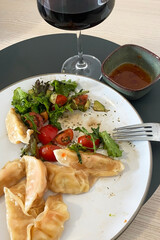 Delicious Dumplings with Fresh Salad and Red Wine Pairing