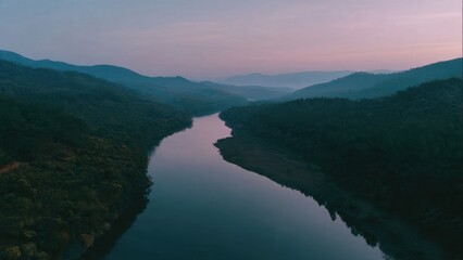 River flowing through green mountains at dusk