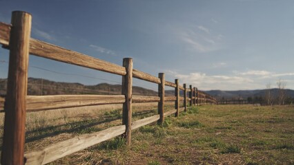 Wooden Fence Along a Grassy Field